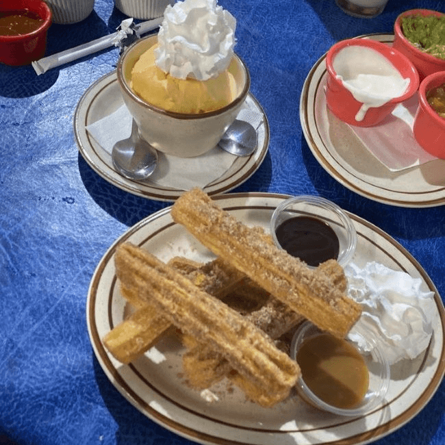 Churros filled with Chocolate & Vanilla Ice Cream.
