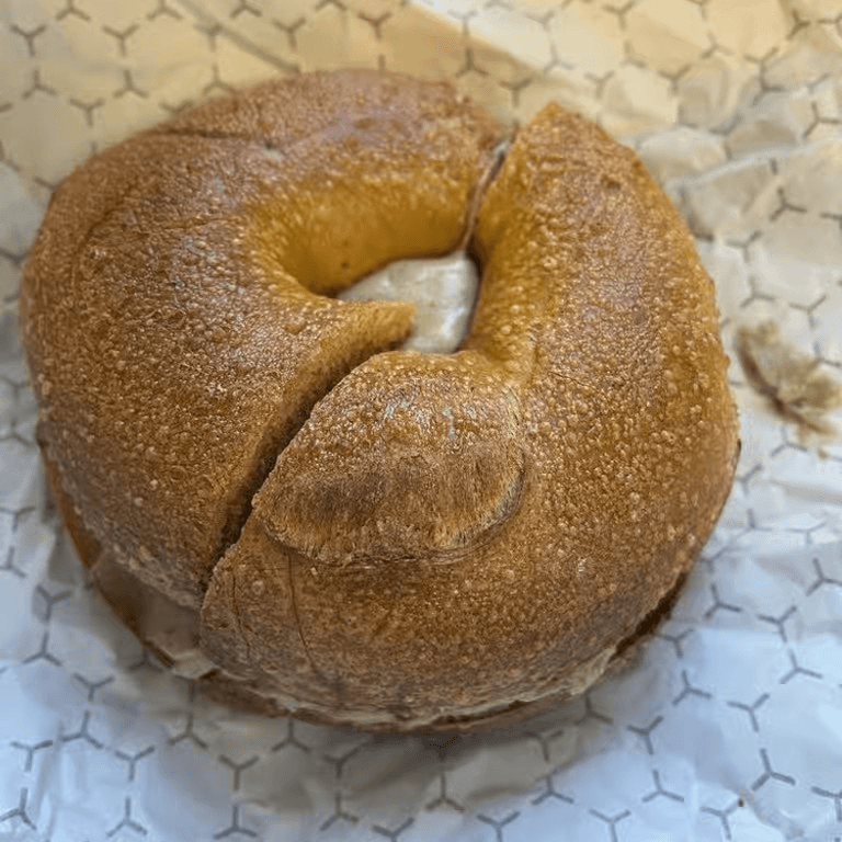 A bagel with maple walnut spread.