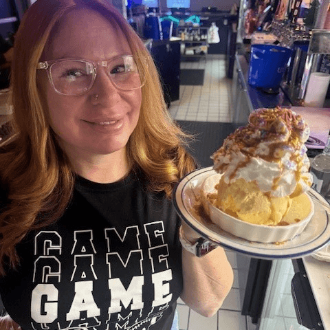 Peanut Butter & Chocolate Chunk Cookie Topped with Scoop of Vanilla Ice Cream.