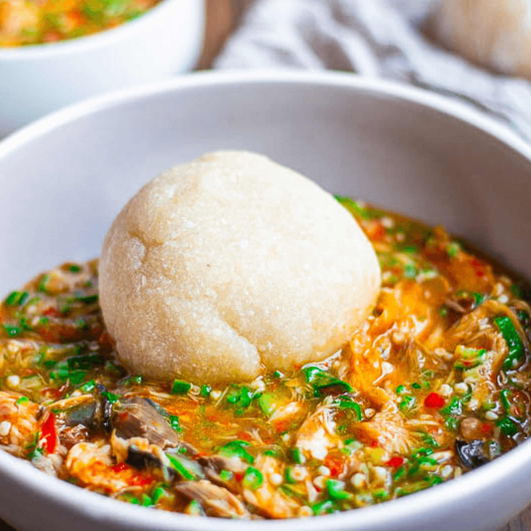 Fufu or Eba with assorted meat Okra Soup.