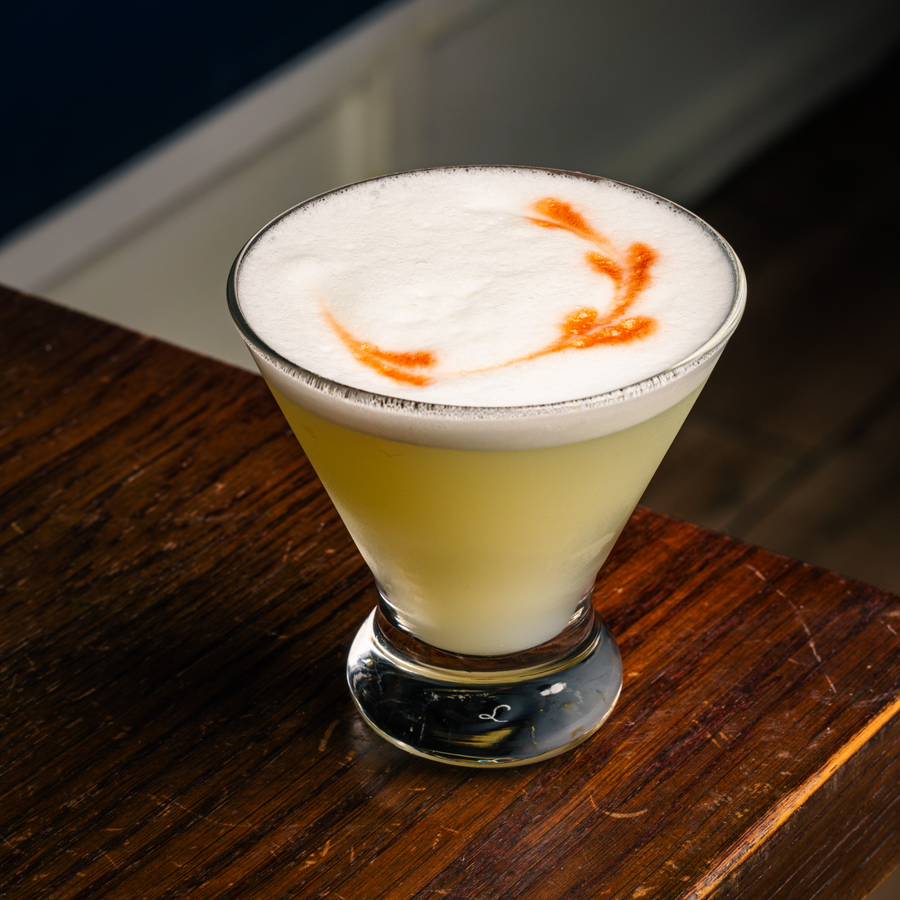 Pisco sour with a foam top at Maura's bar