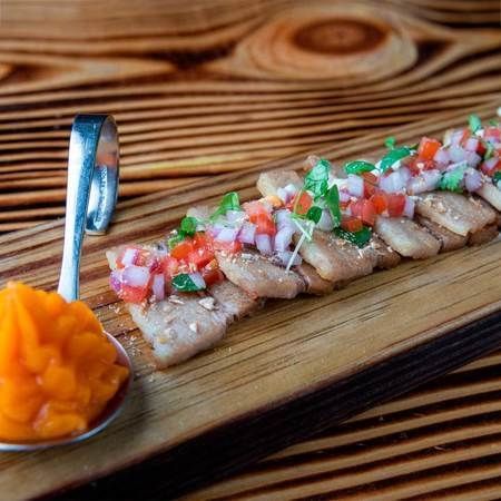 Pork Belly Con Chalaca Y Salsa Acevichada.