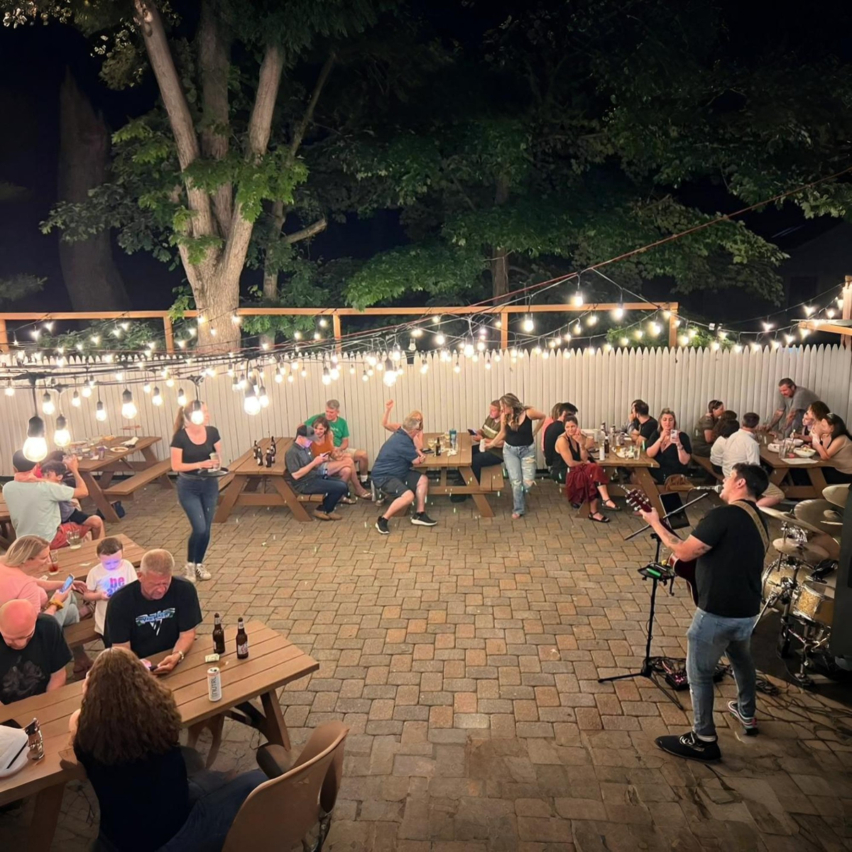 The patio at night under string lights