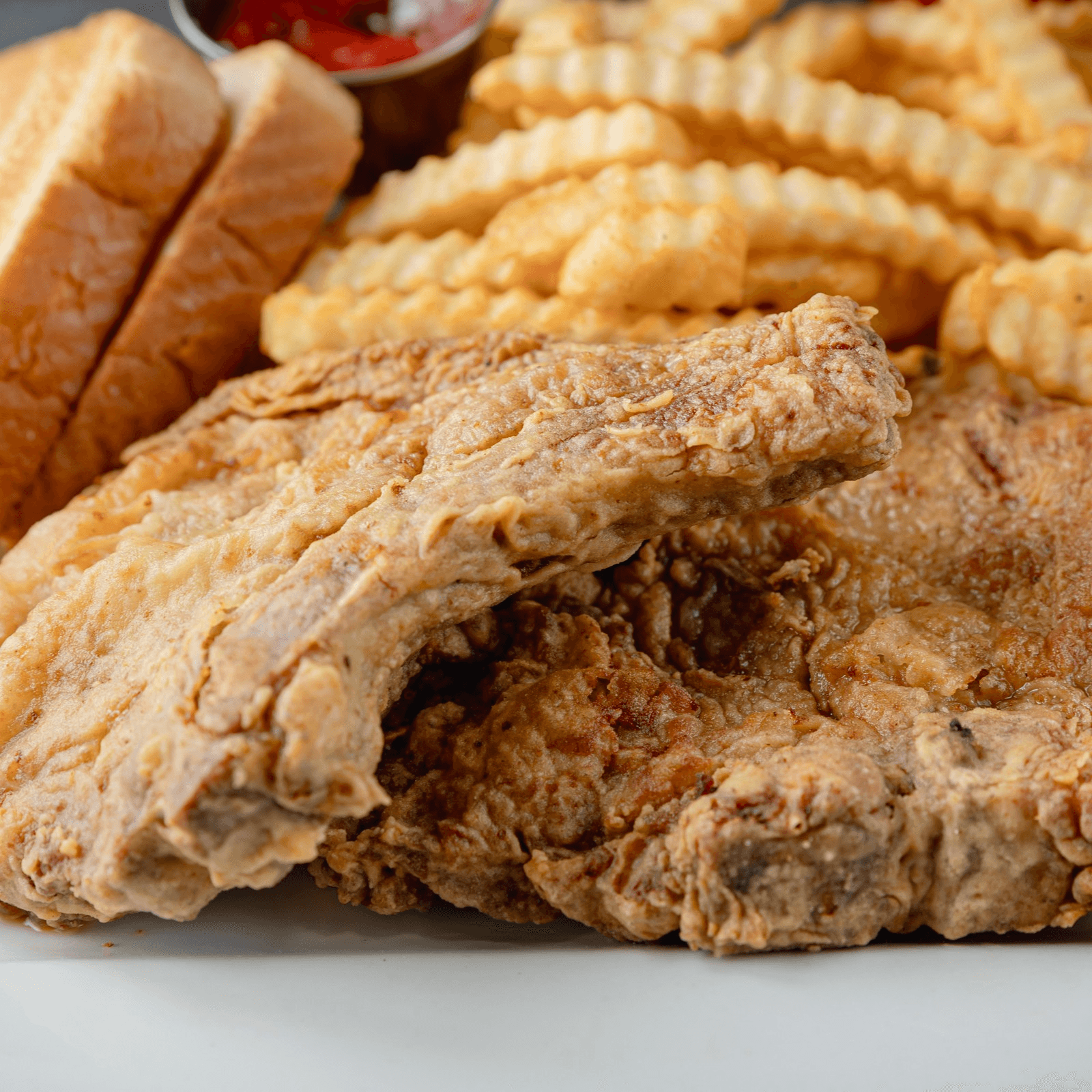 KAJUN BONE-IN PORK DINNER.