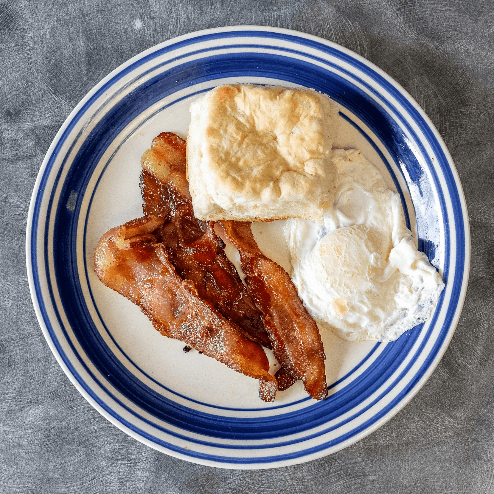 One Egg Your Choice of Meat, Side and Bread.