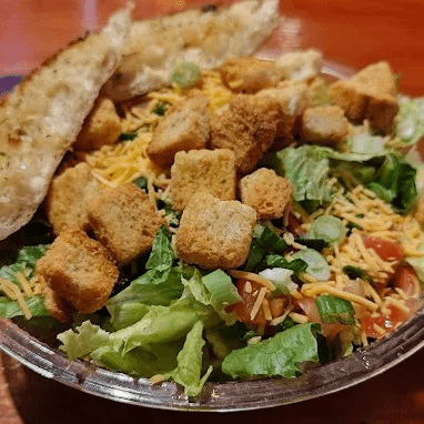 Tossed Green or Caesar Salad.