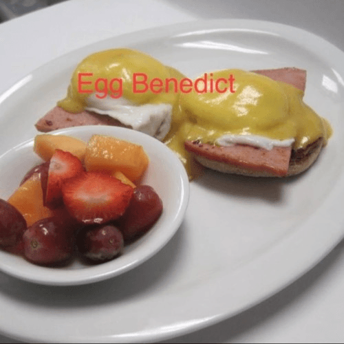 Ham Benedict with fruit cup.
