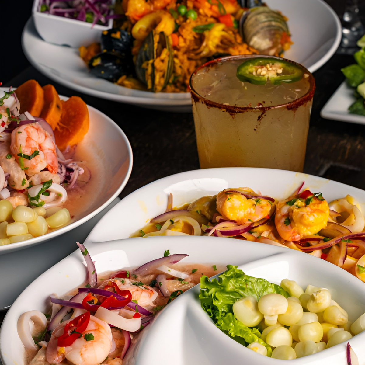 A spread of Peruvian tapas with ceviche, choclo and jalea and a spicy cocktail