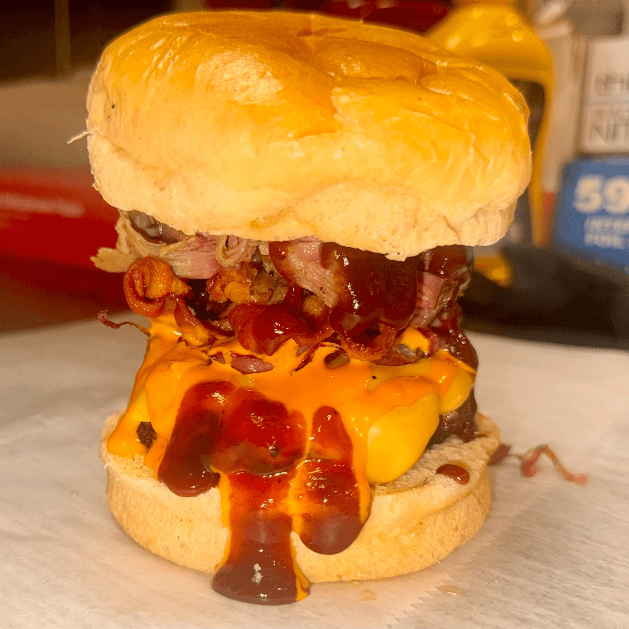 Grilled Burger Topped with Bacon & Pulled Pork Sandwich.