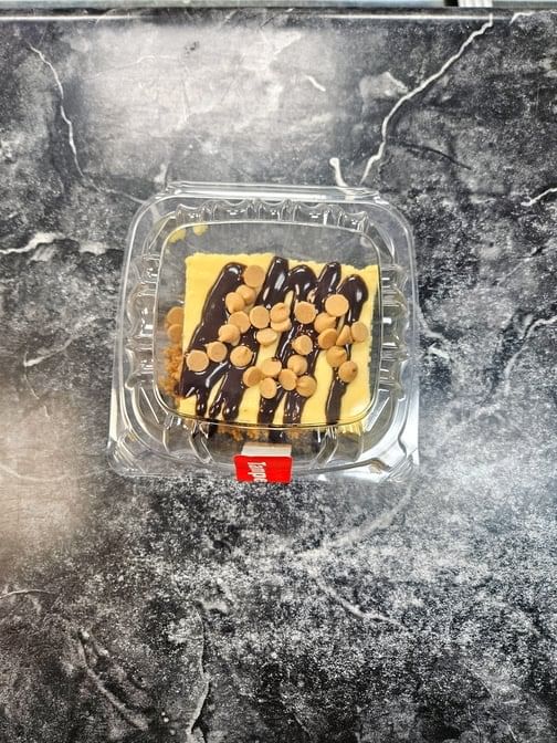 Cheesecake with Hershey Drizzle and Reeses Peanut Butter Cup Chips.