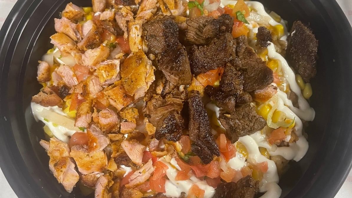 BUY ONE GET ONE Santa Fe Style Rice and Beans with Half Chicken and Half Steak.