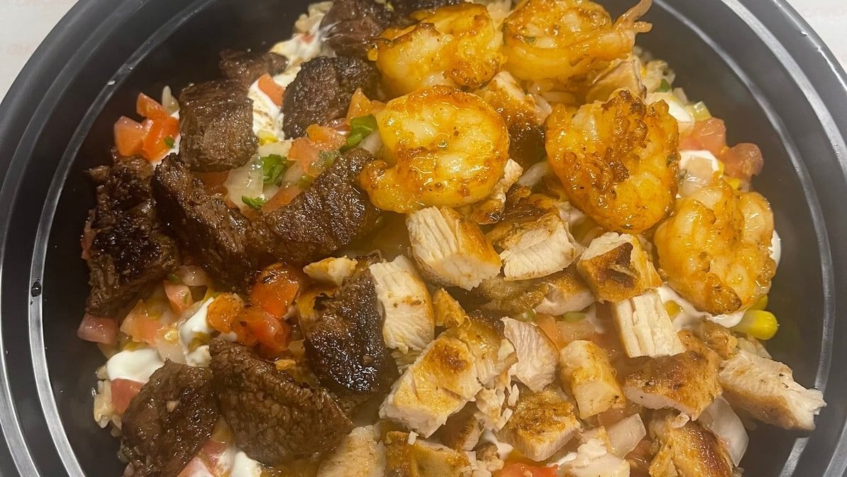 BUY ONE GET ONE Santa Fe Style Rice and Beans with Half Chicken, Half Steak, and Half Shrimp.