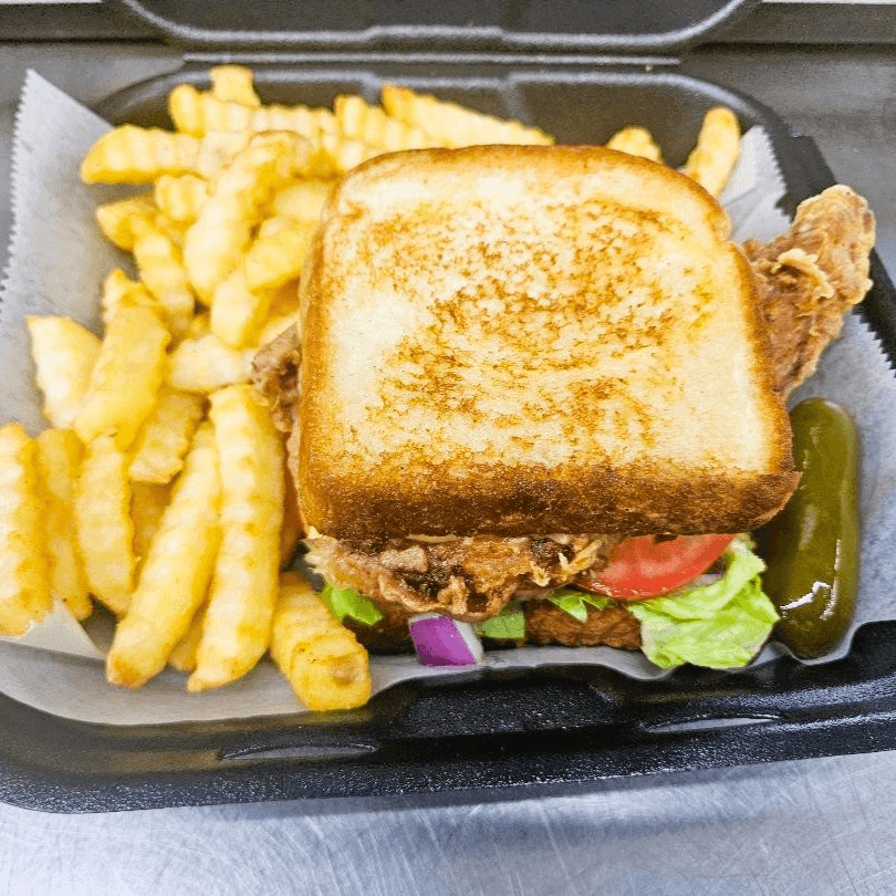 KAJUN BONE-IN PORK CHOP SANDWICH W/ FRIES.