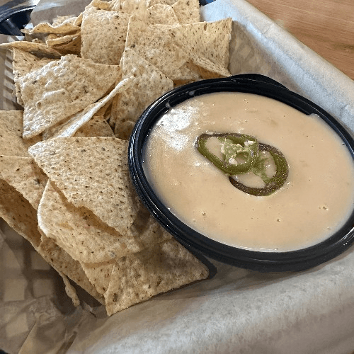 Queso with corn tortilla chips.