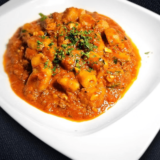 Pappardelle or Gnocchi alla Bolognese.