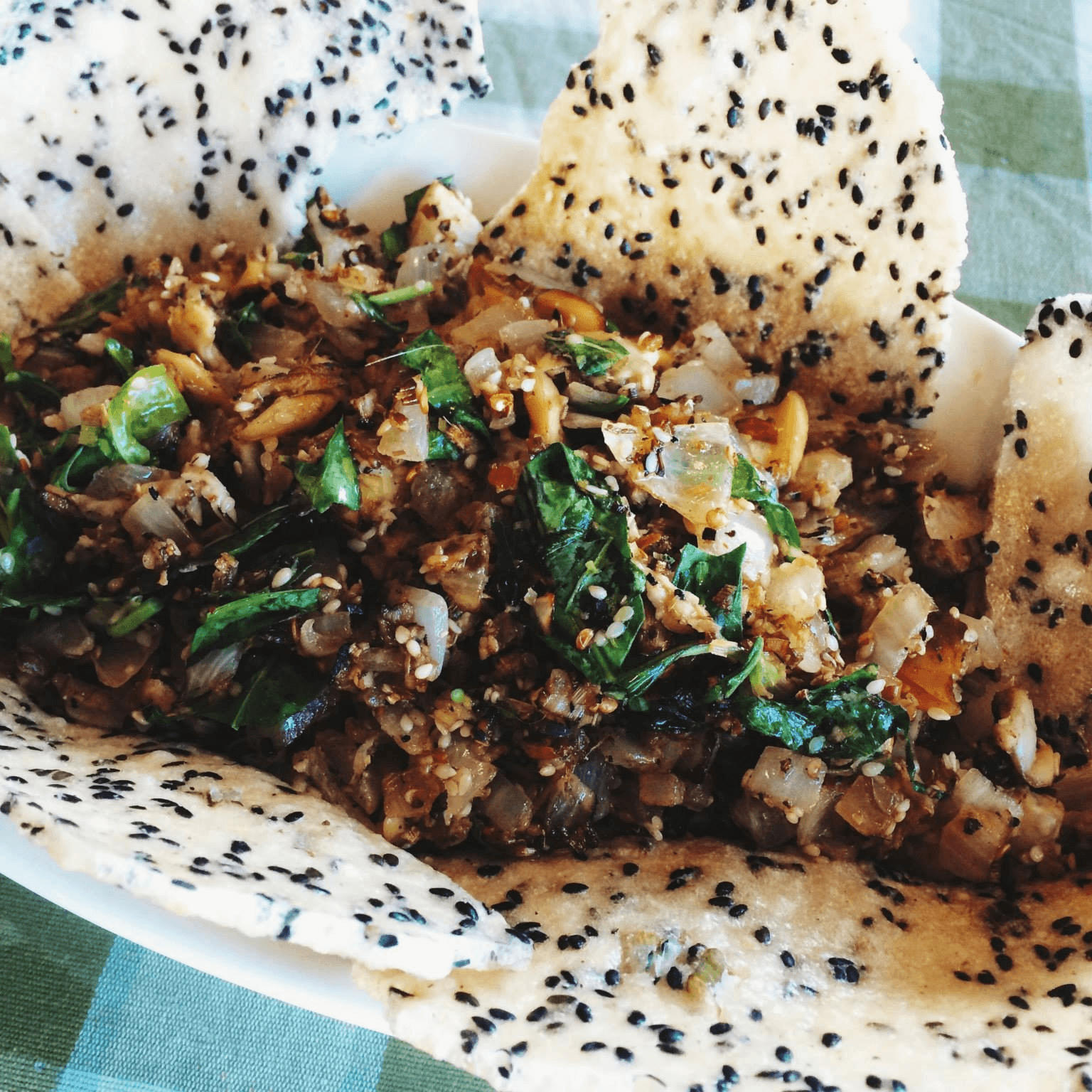 Stir-fried clams with sesame rice crackers.