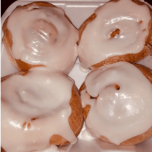 Four Glazed Cinnamon Rolls.