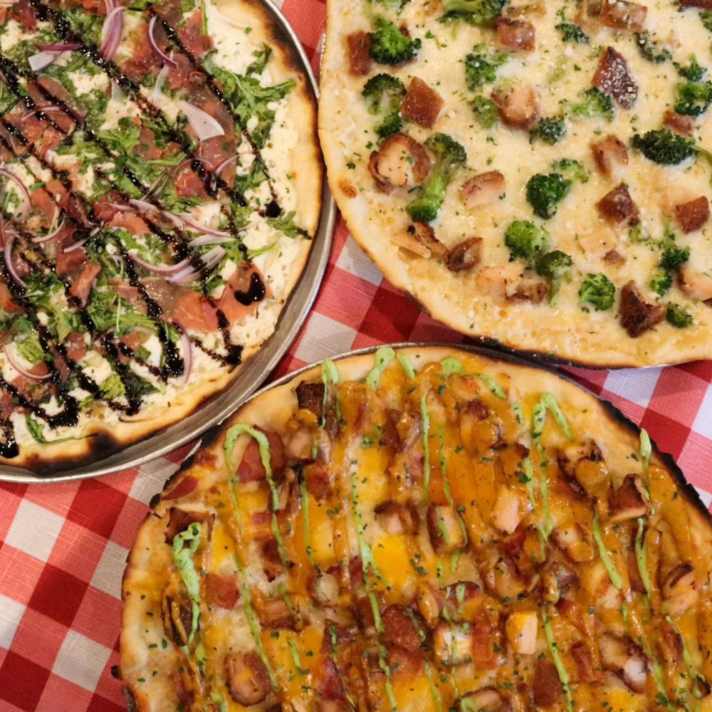 Three thin-crust pizzas on gingham