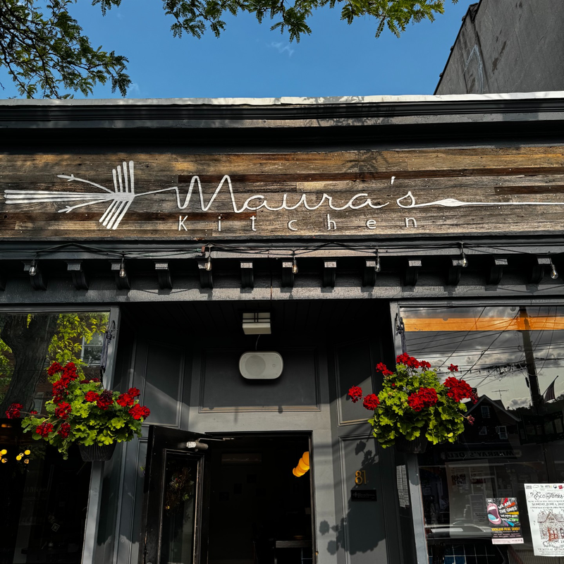 The Maura's Kitchen storefront with hanging flower baskets