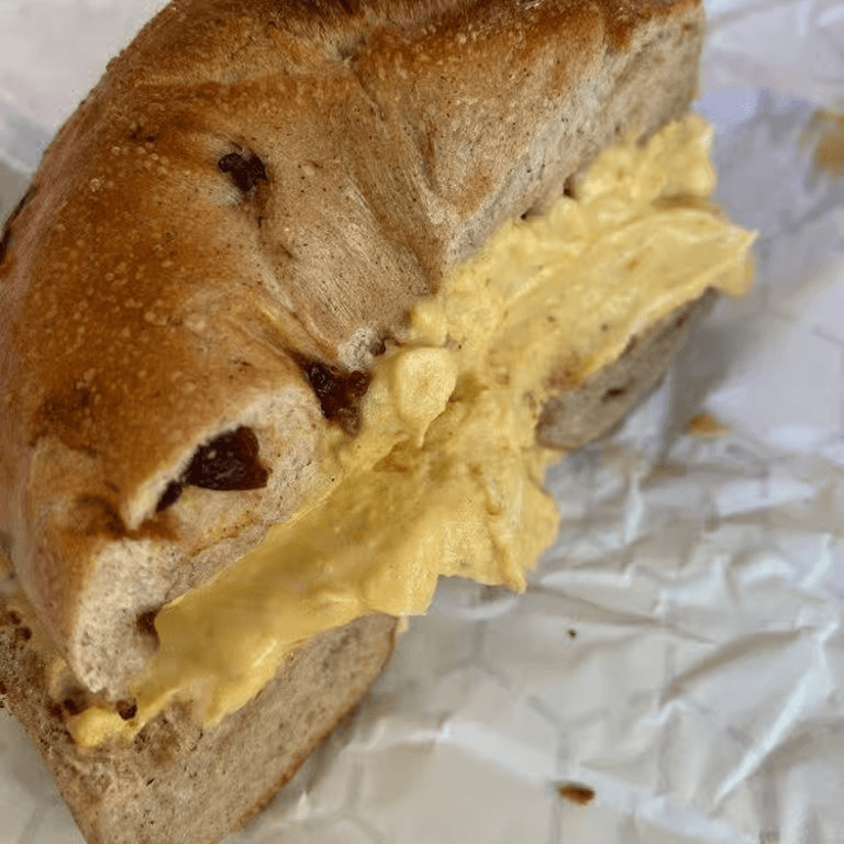 A bagel with cinnamon raisin spread.