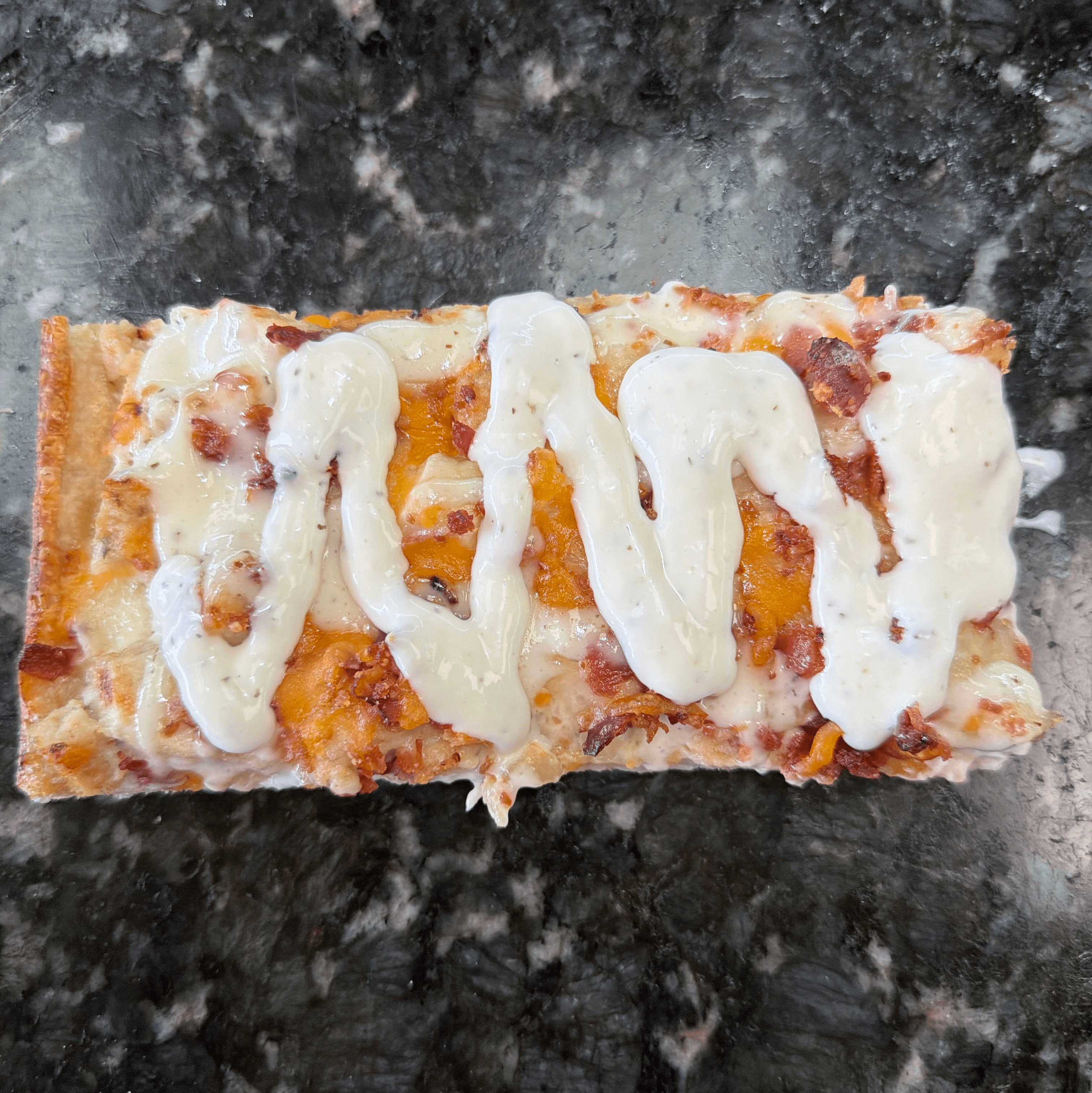 Bacon Chicken Ranch Pizza Slice.