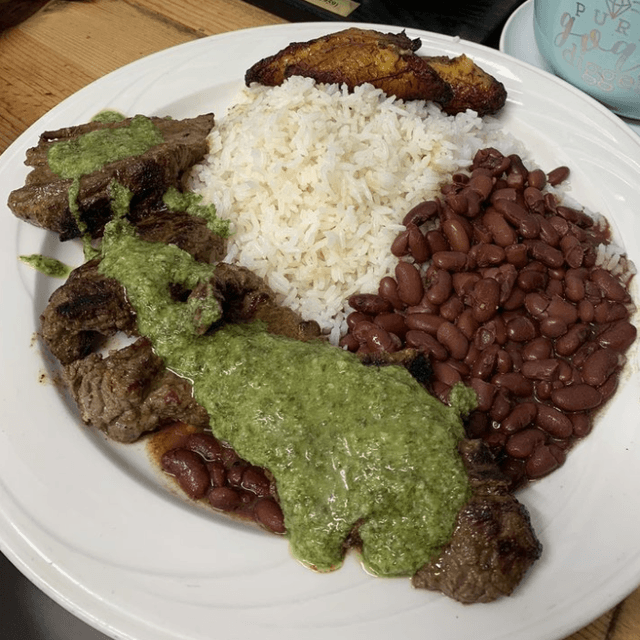 Skirt Steak (Churraszco) Served With Rice,Beans, (Gallo Pinto)Home Made Chimichurri Choice Of Sweet,Totones Or Corn Tortilla.