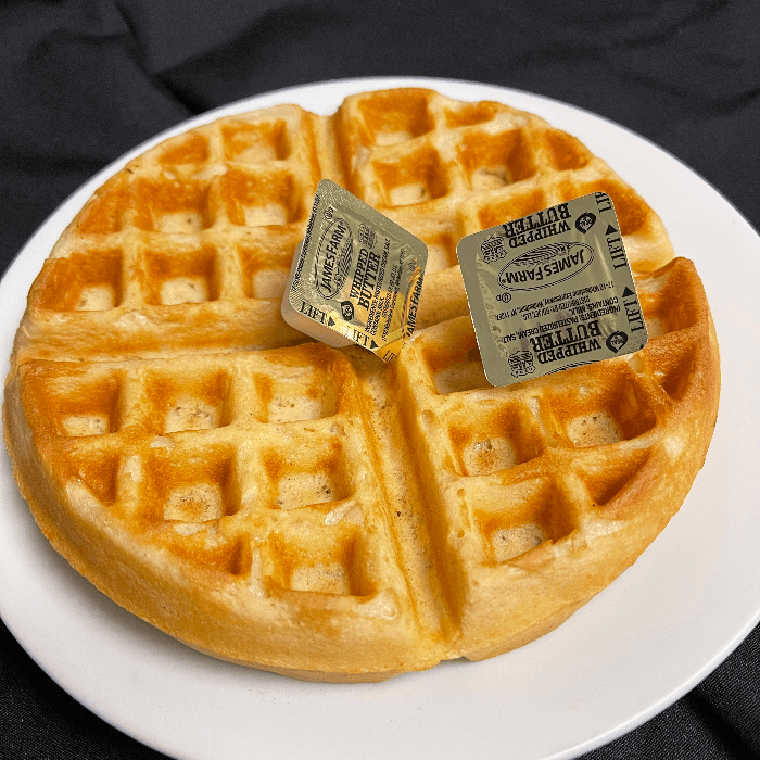 Plain Belgian waffle with butter and syrup.