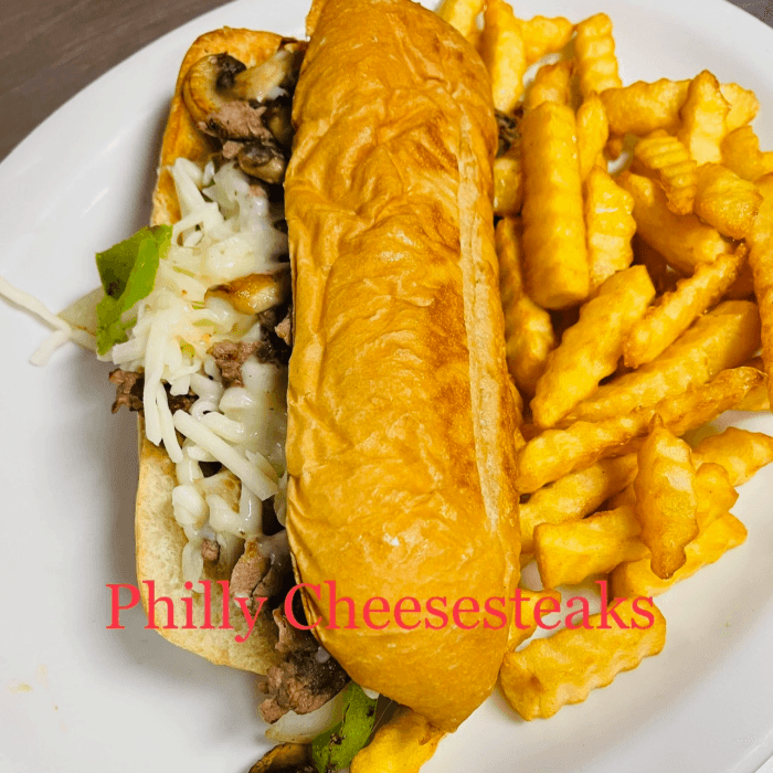 Philly Cheesesteak Sandwich with fries.