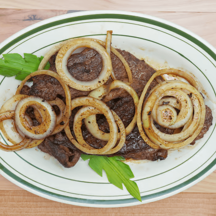 Bistec Encebollado / Onions Steak Platter.