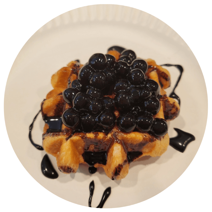 Belgian waffle topped with tapioca boba and chocolate drizzle