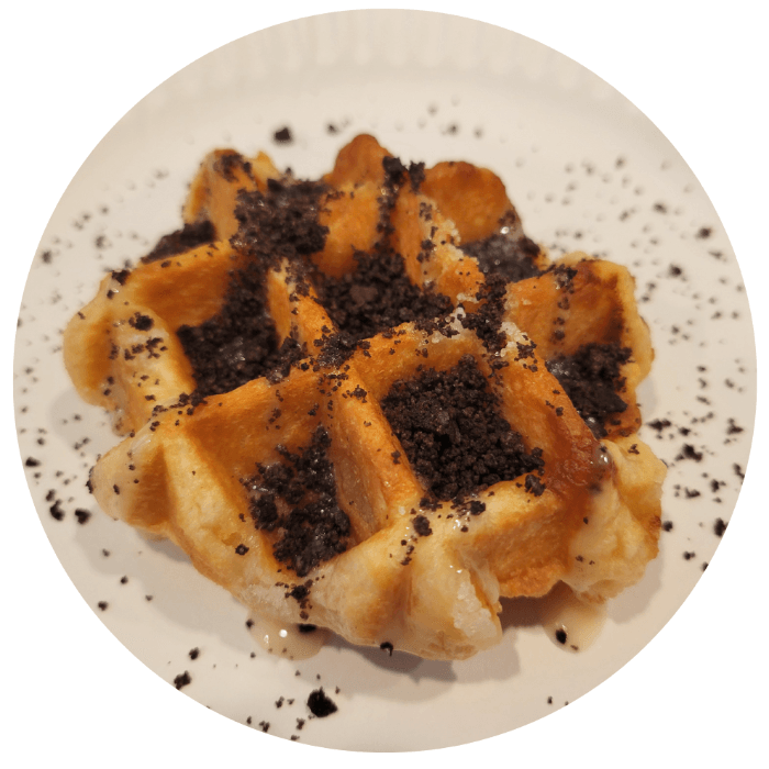 Belgian waffle drizzled with condense milk and oreo crunches