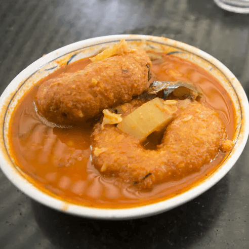 Medu vada in sambar or rasam bowl