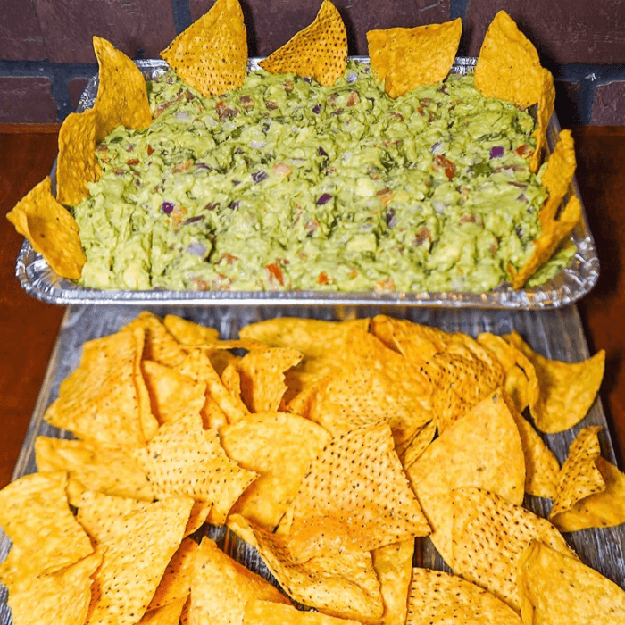 QUATER TRAY OF GUAC AND CHIPS.