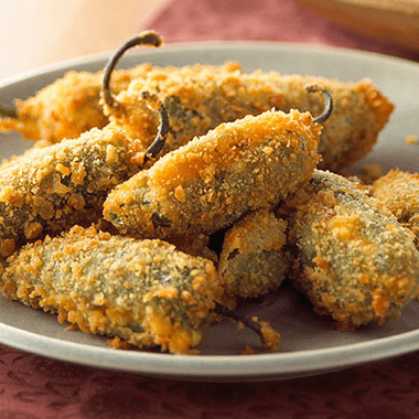 Jalapenos Rellenos; Six Crispy Jalapeno Poppers Stuffed with Cream Cheese and Wrapped with Crispy Bacon. Served with Guacamole Salad.
