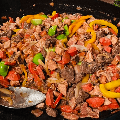 Discada; ( Discada is a Mixure of Choped Carne Asada, Onions, Bell Peppers, Mushrooms, Jalapenos, Chorizo, Sausage and Melted Cheese Sauteed in its Own Juices )   