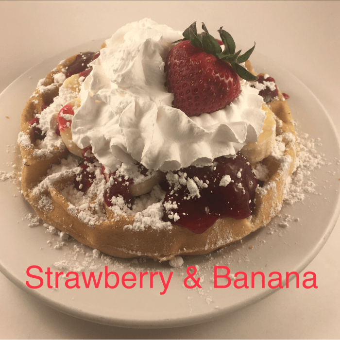 3 Strawberry Banana Pancake with Whipped Cream and Powdered Sugar.