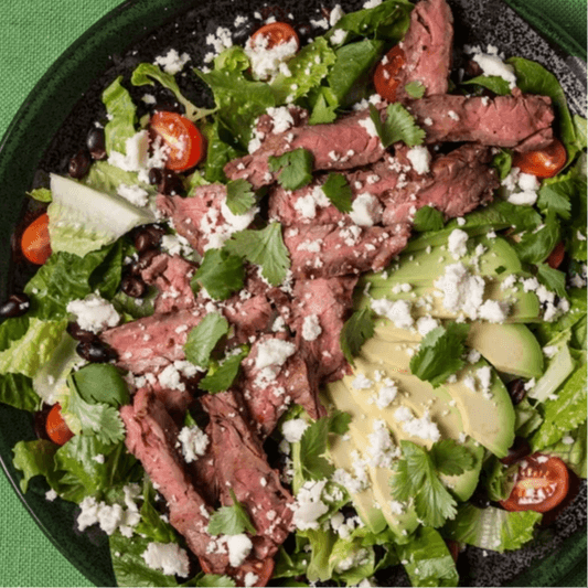 Salad topped with Steak