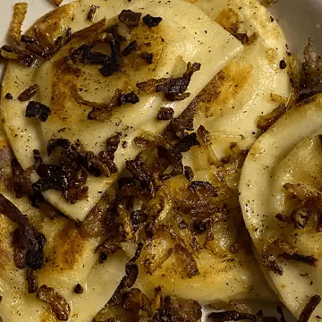 Ken's Famous Grilled Pierogies  with Butter & Onions