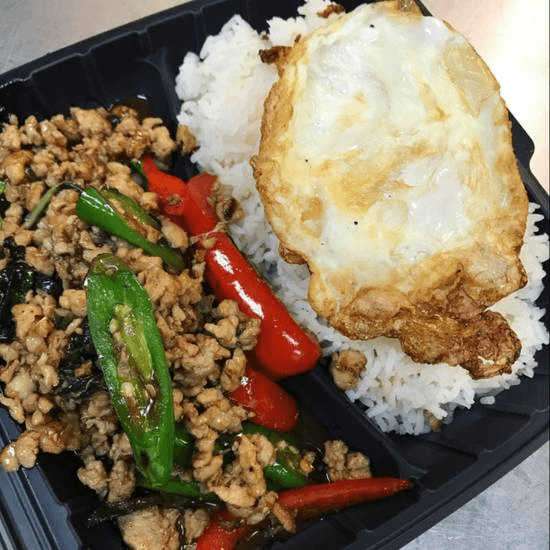 Basil leaves ground chicken over rice with fried egg