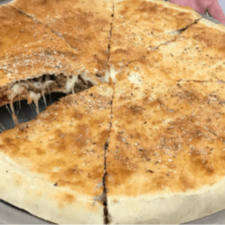 Two Layers of Pizza Crust, Stuffed with a Layer of Pepperoni, Sausage, Ground Beef