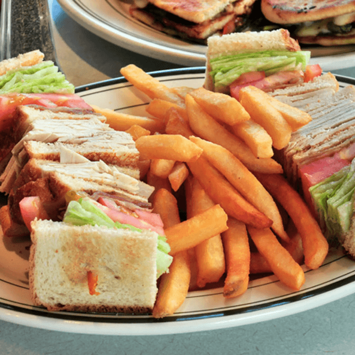 Sliced Turkey and Bacon Triple Decker Sandwich.